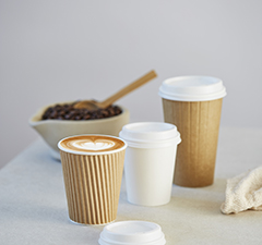 Three coffee cups and small bowl with coffee beans