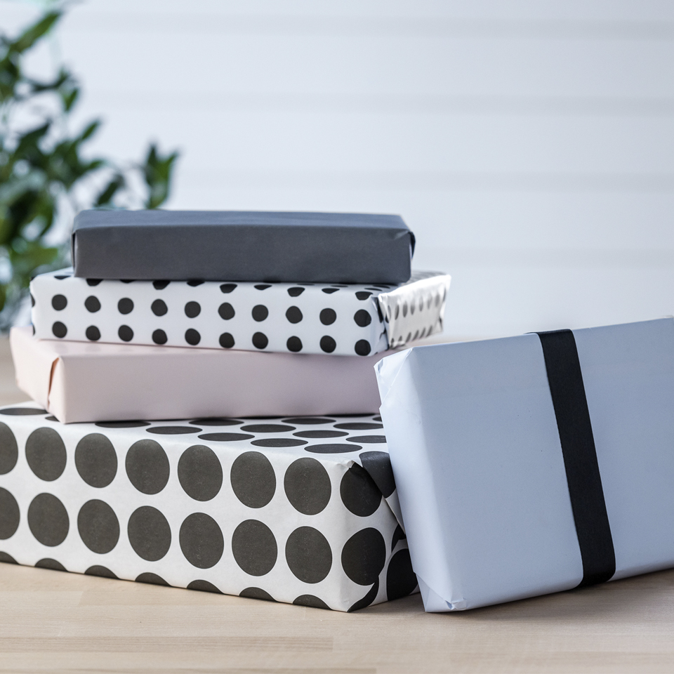 Image of four gift wrapped boxes stacked on top of each other.