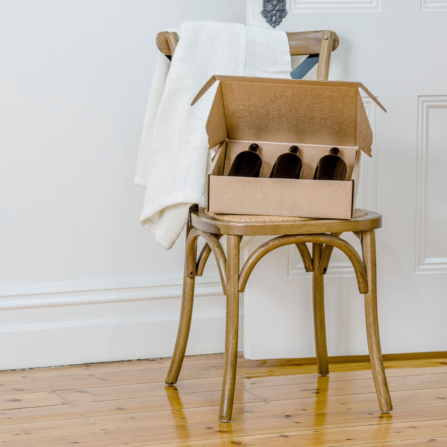 Image of wine bottles, packaged, sitting on a wooden chair