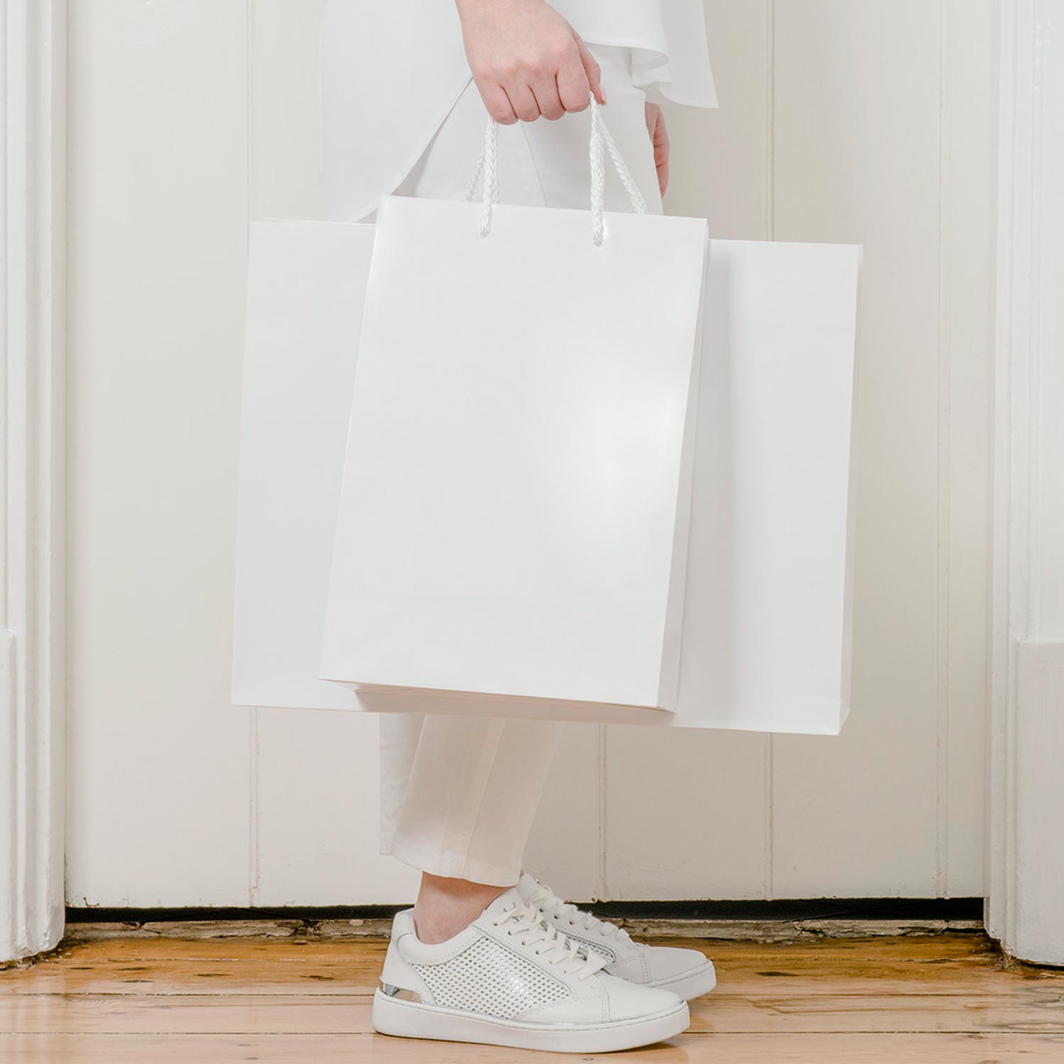 Image of person carrying paper carry bags